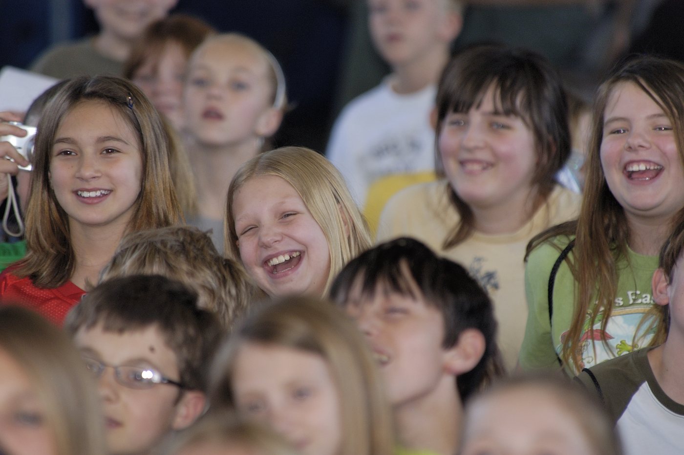 A room of school children laughing during a Mark Wade performance