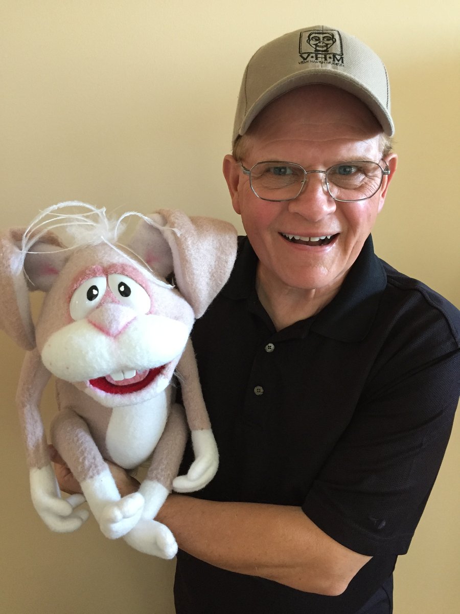 Mark Wade in a Vent Haven Museum cap holding a rabbit figure