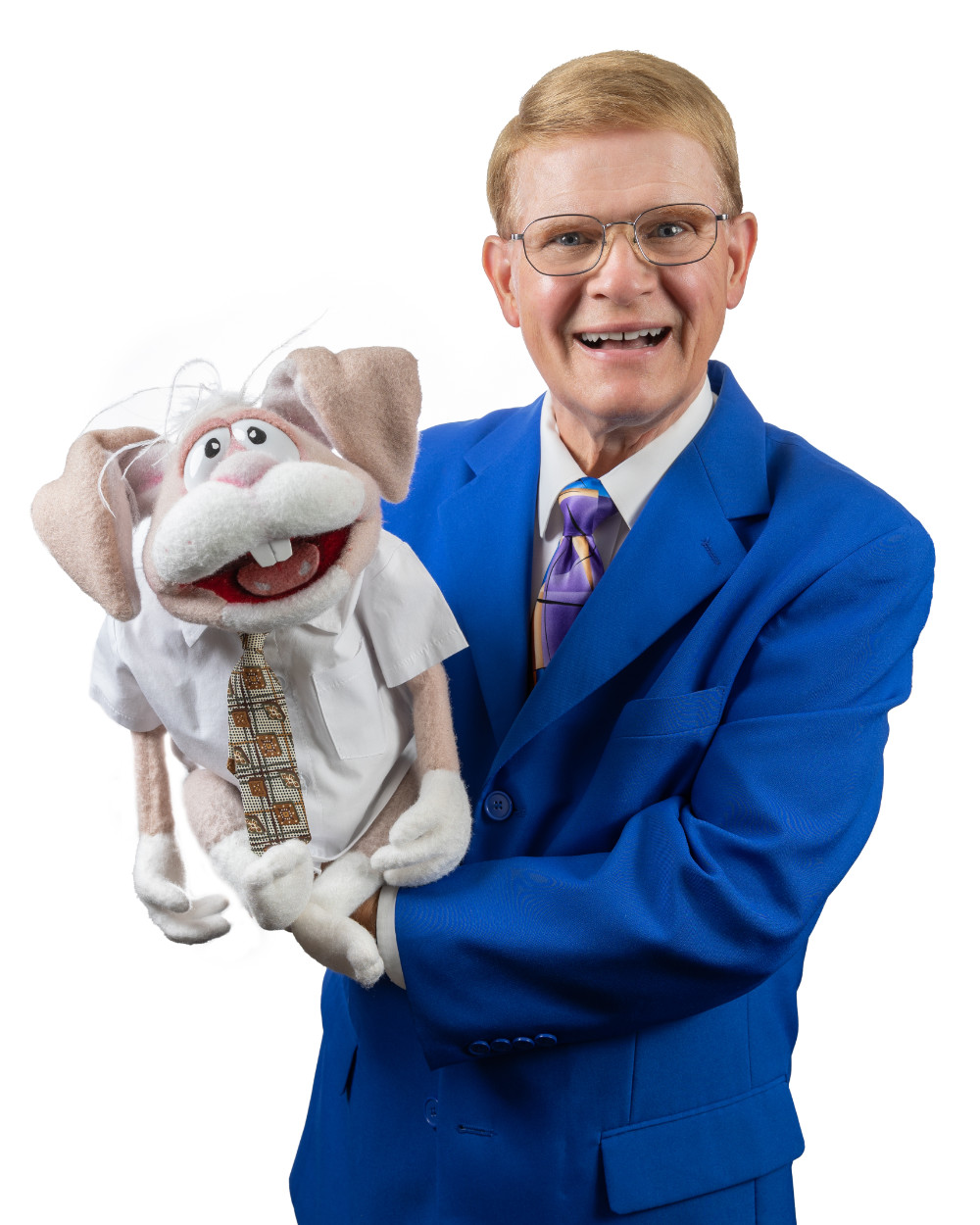 Mark Wade in a blue suit holding one of his puppet partners